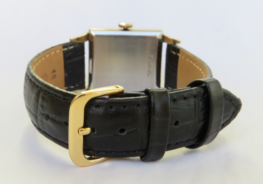 A gents vintage 1950s square gold-cased Gruen Veri-Thin wristwatch with a textured dial and a black alligator-grain leather strap. View VI