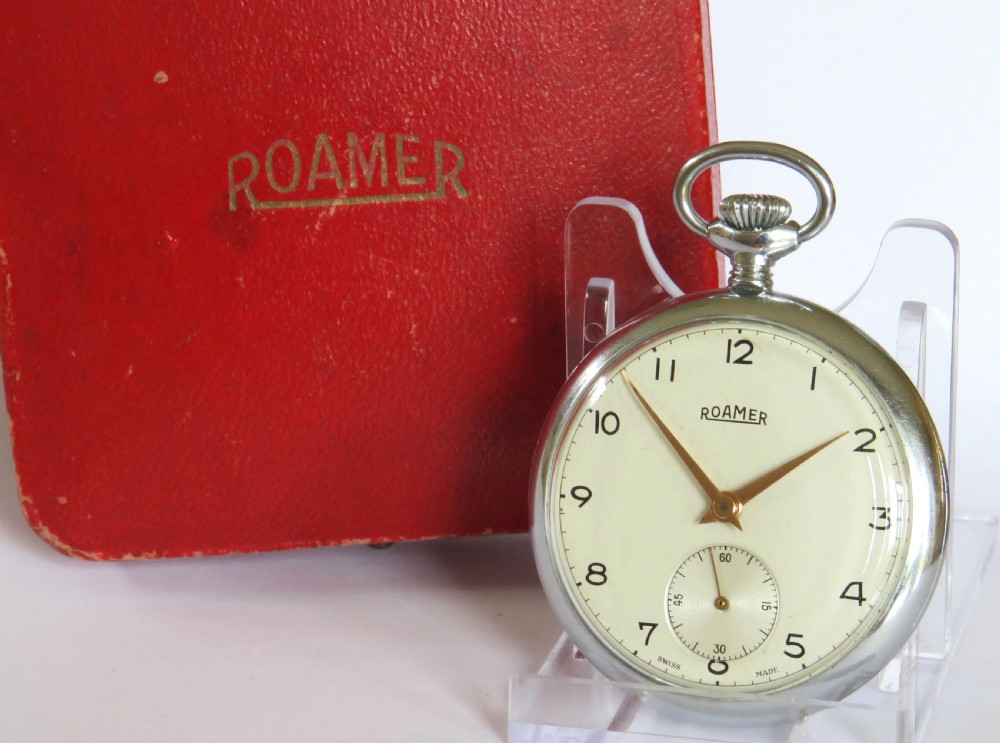 A vintage 1950s Roamer open-face pocket watch featuring a cream dial with Arabic numerals, gold-tone hands, a sub-seconds dial, and its original red presentation box.