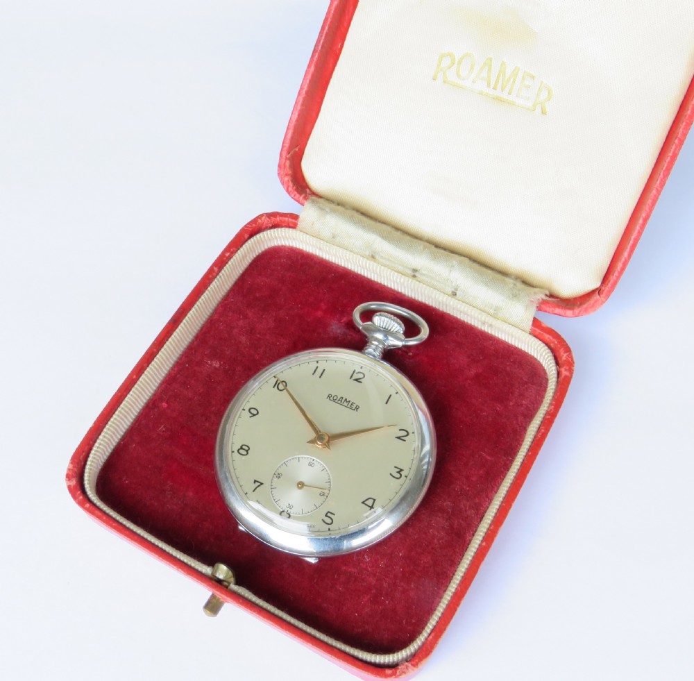 A vintage 1950s Roamer open-face pocket watch featuring a cream dial with Arabic numerals, gold-tone hands, a sub-seconds dial, and its original red presentation box. View II