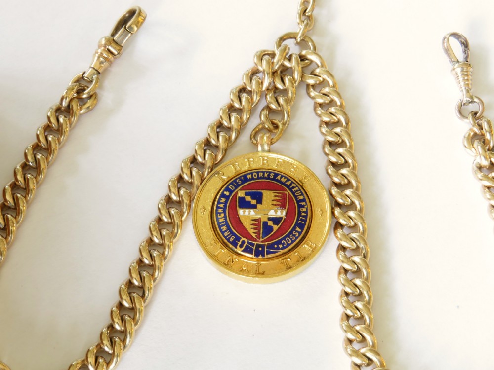 A gold filled double Albert watch chain featuring heavy curb links, a central T-bar, two swivel clasps, and a circular enamelled fob. View II