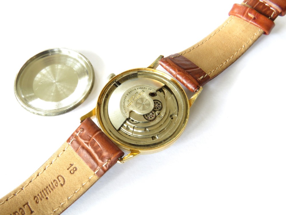 A 1960s Atlantic Super Automatic gents wristwatch with a black dial, gold hour markers, and a brown leather strap. View III