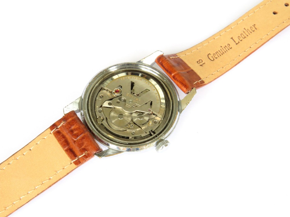 A 1950s mens Enicar Ultrasonic automatic wristwatch featuring a circular silver-tone case, cream dial with hour batons, date window, and a brown leather strap. View II