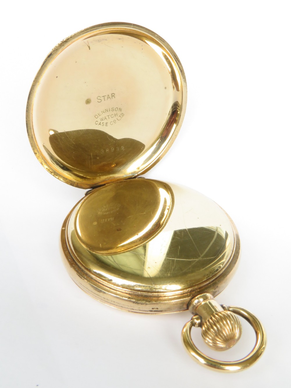 An open gold-toned half hunter pocket watch featuring a white enamel dial with Roman numerals and a subsidiary seconds dial. View IV