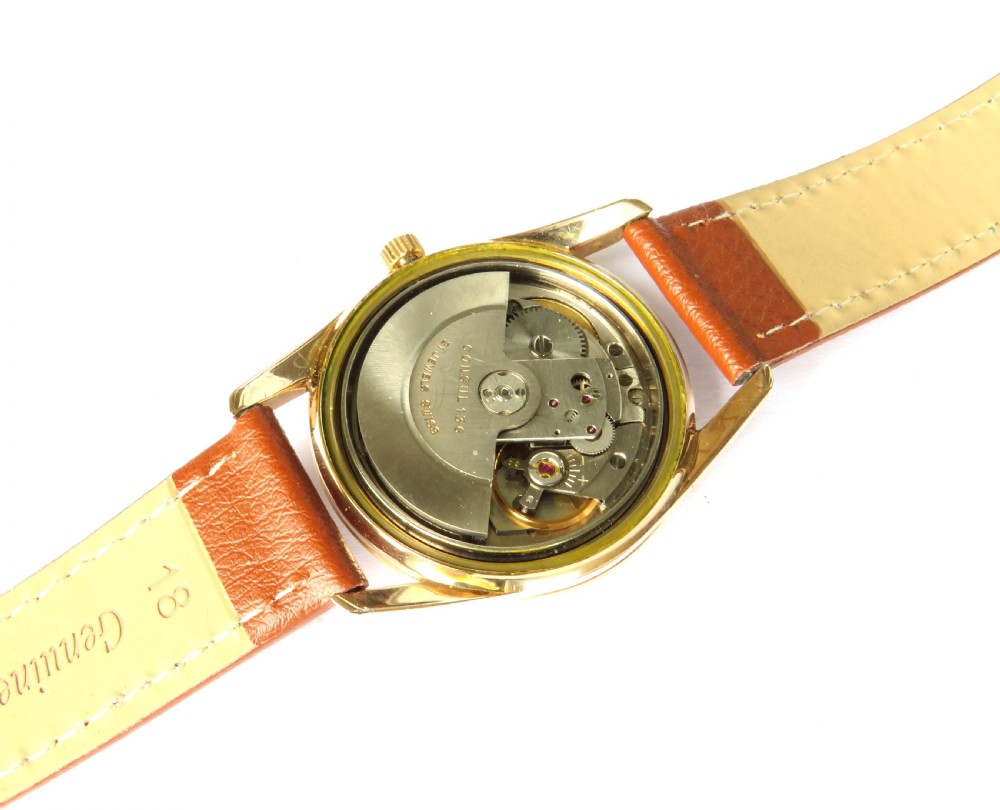 A 1960s gents Consul Dermaphile automatic wristwatch with a gold-tone case, champagne dial, faceted border indices, date window, and brown leather strap. View IV
