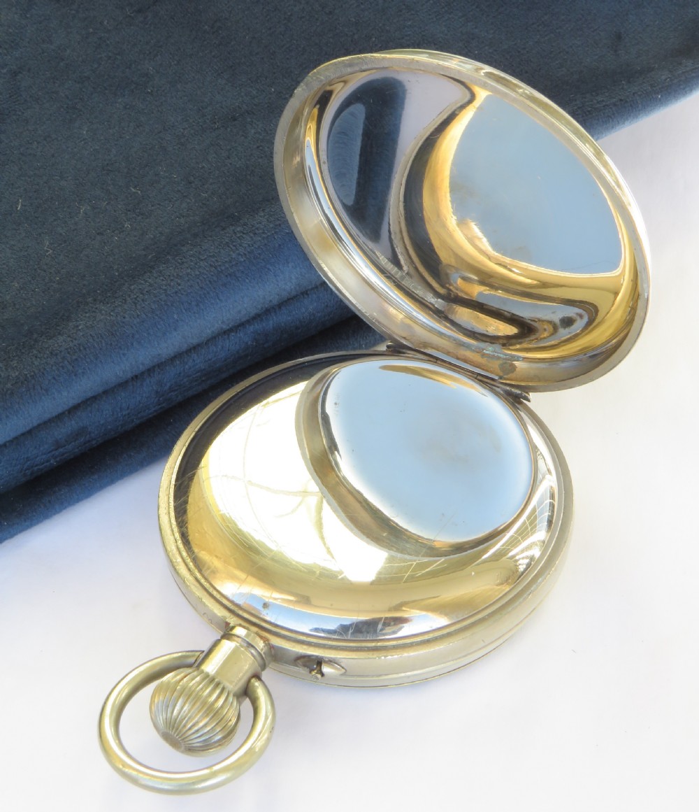 An antique open-face Goliath pocket watch featuring a white enamel dial with black Arabic numerals, a subsidiary seconds dial at the six oclock position, and a top winding loop. View III