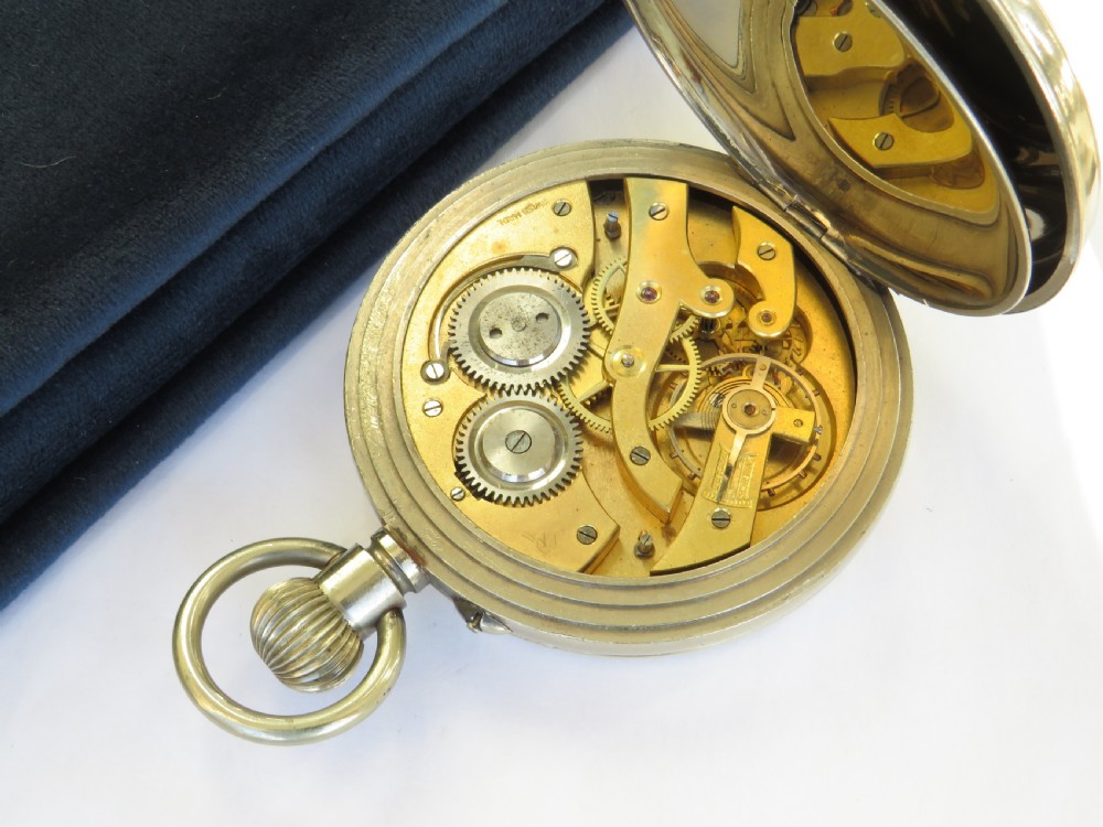 An antique open-face Goliath pocket watch featuring a white enamel dial with black Arabic numerals, a subsidiary seconds dial at the six oclock position, and a top winding loop. View IV