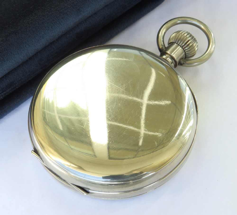 An antique open-face Goliath pocket watch featuring a white enamel dial with black Arabic numerals, a subsidiary seconds dial at the six oclock position, and a top winding loop. View V