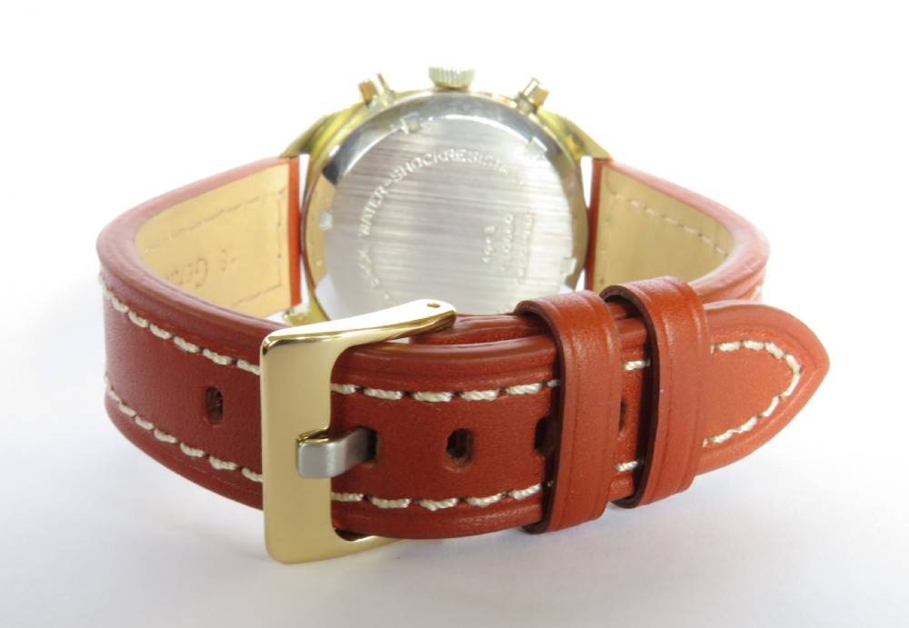 A 1960s Mappin chronograph wristwatch featuring a gold-coloured cushion case, silver-white dial with twin sub-dials, and a brown leather strap. View III