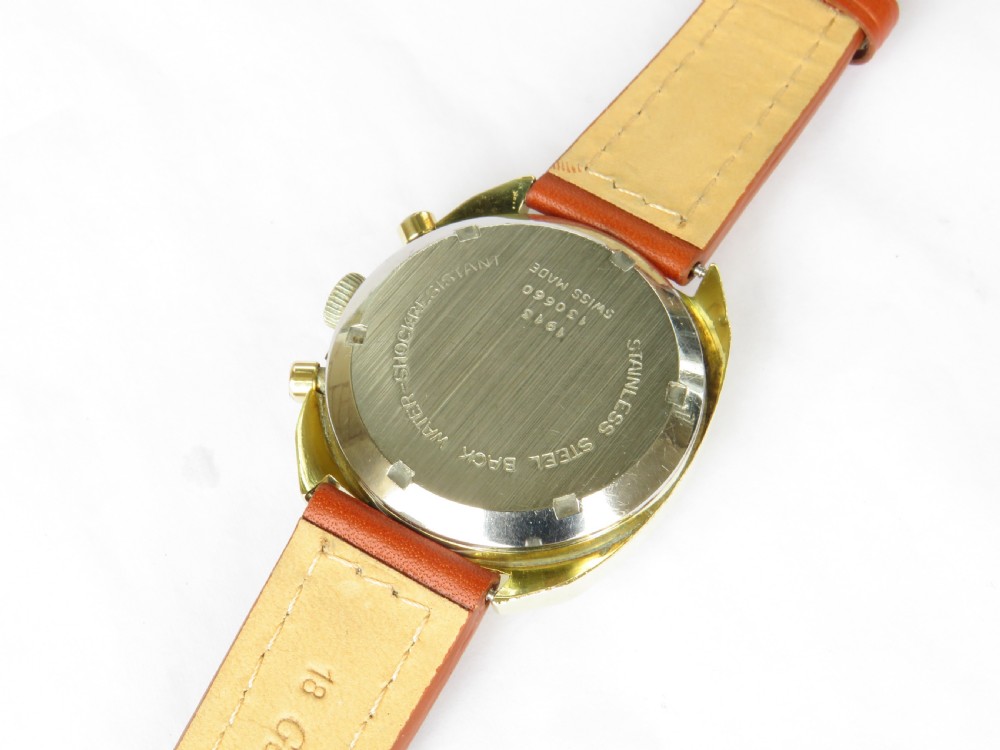 A 1960s Mappin chronograph wristwatch featuring a gold-coloured cushion case, silver-white dial with twin sub-dials, and a brown leather strap. View IV
