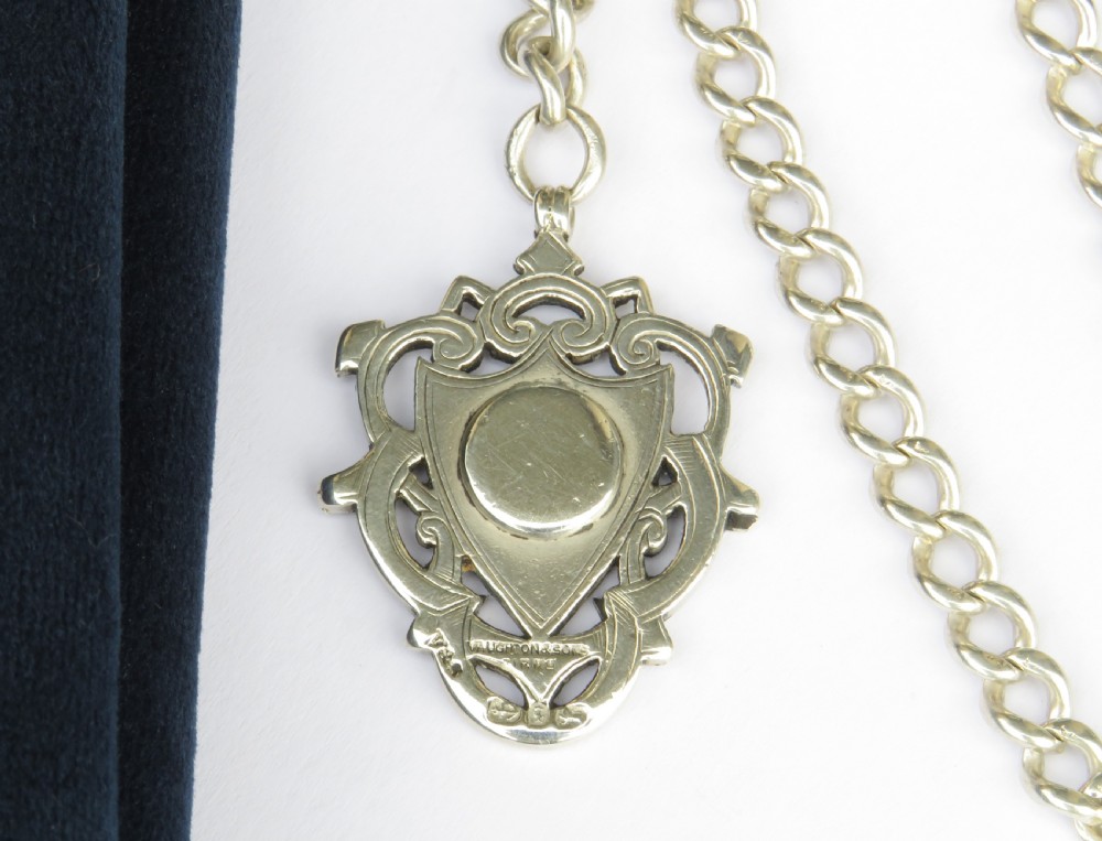 An antique silver curb link pocket watch chain featuring a T-bar, swivel clasp, and a heraldic enamelled shield fob. View III