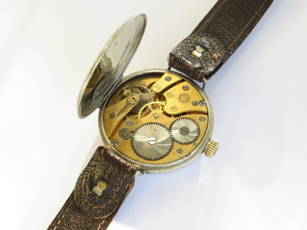An antique West End Watch Co wrist watch featuring a white enamel dial with Arabic numerals, sub-seconds dial, and a brown leather strap. View III