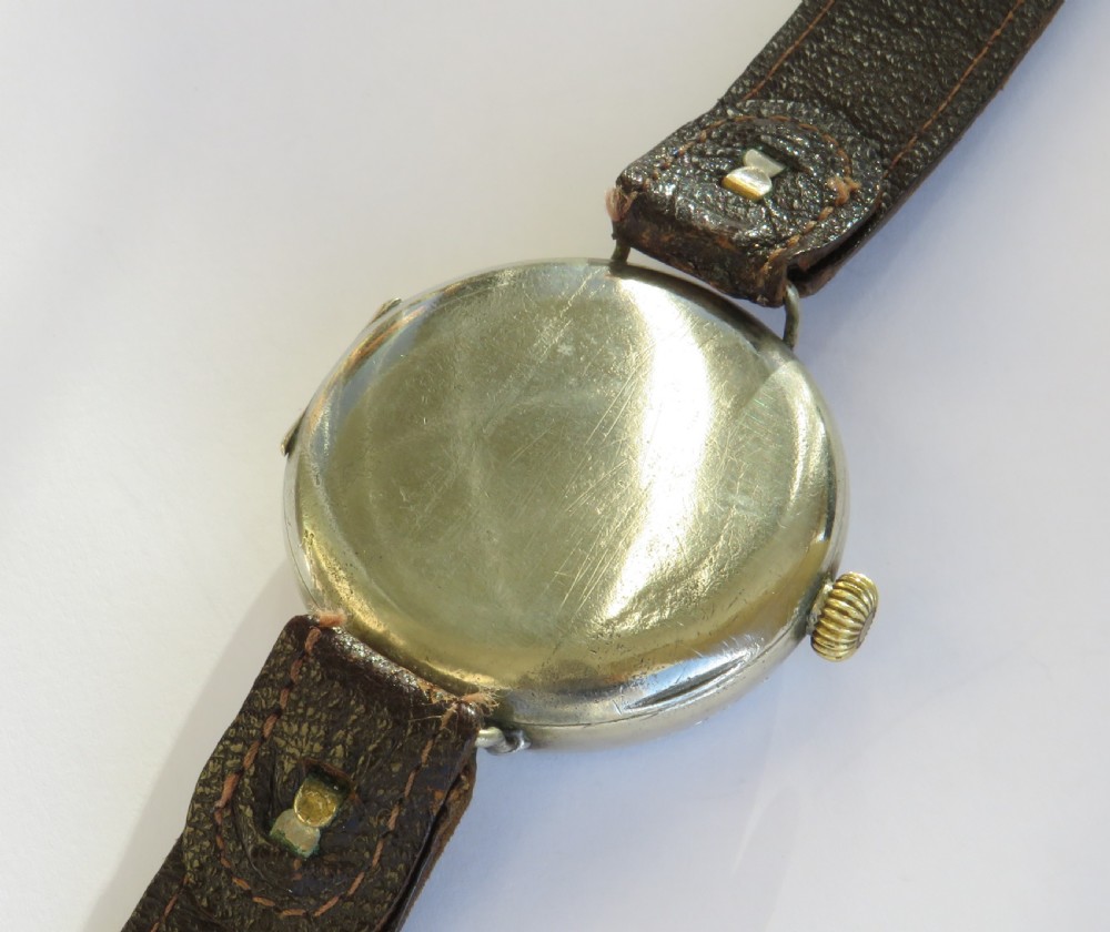 An antique West End Watch Co wrist watch featuring a white enamel dial with Arabic numerals, sub-seconds dial, and a brown leather strap. View IV