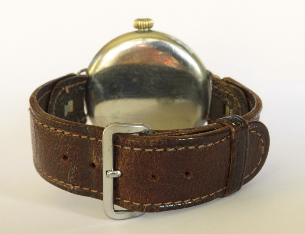 An antique West End Watch Co wrist watch featuring a white enamel dial with Arabic numerals, sub-seconds dial, and a brown leather strap. View V