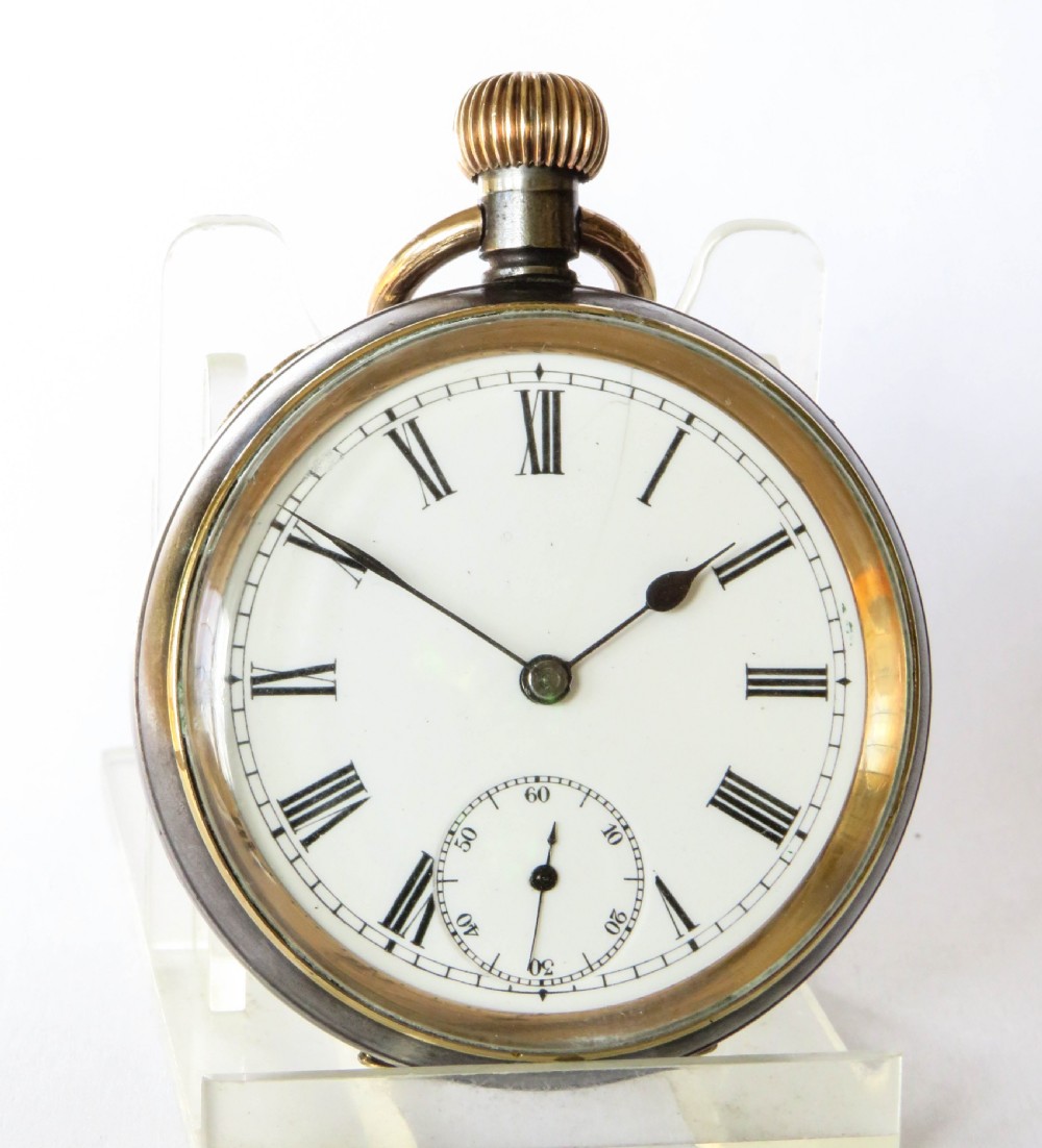 An open-face antique gunmetal pocket watch featuring a white enamel dial with black Roman numerals, gold-toned rim, and a subsidiary seconds sub-dial. View II