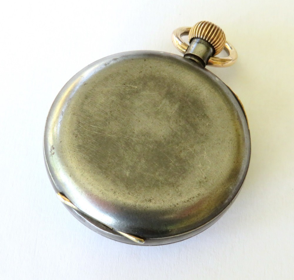 An open-face antique gunmetal pocket watch featuring a white enamel dial with black Roman numerals, gold-toned rim, and a subsidiary seconds sub-dial. View V