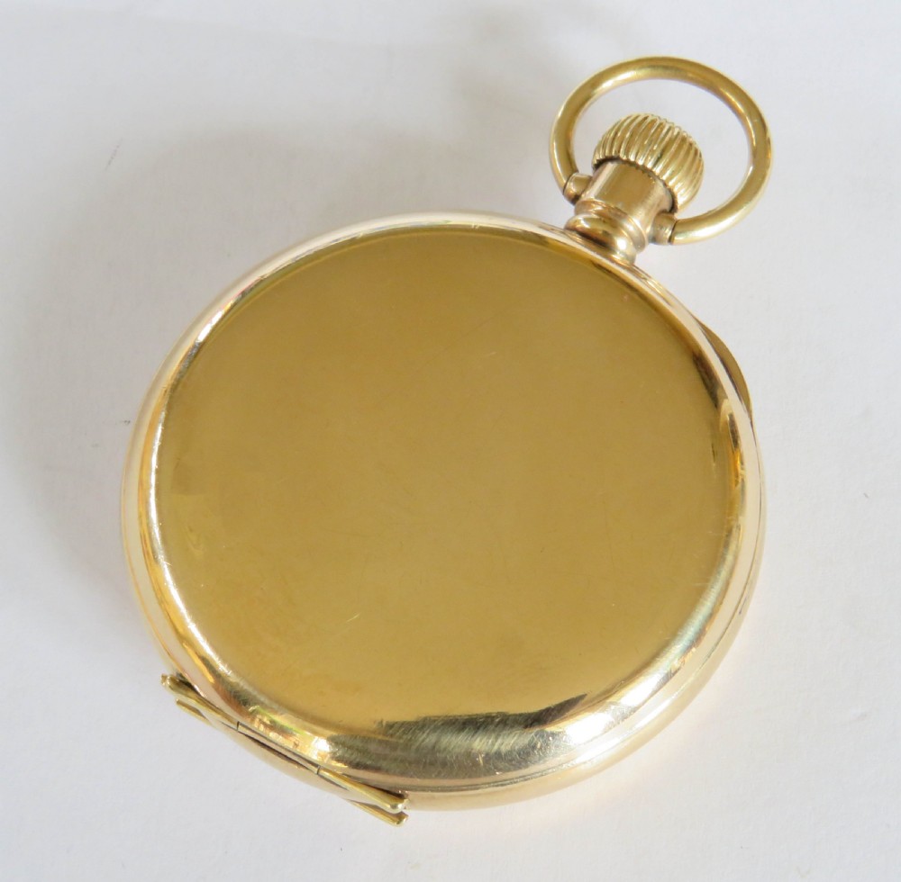 An open-face 1920s gold-coloured pocket watch by Stayte Tavannes featuring a white dial with black Roman numerals and a subsidiary seconds dial. View IV