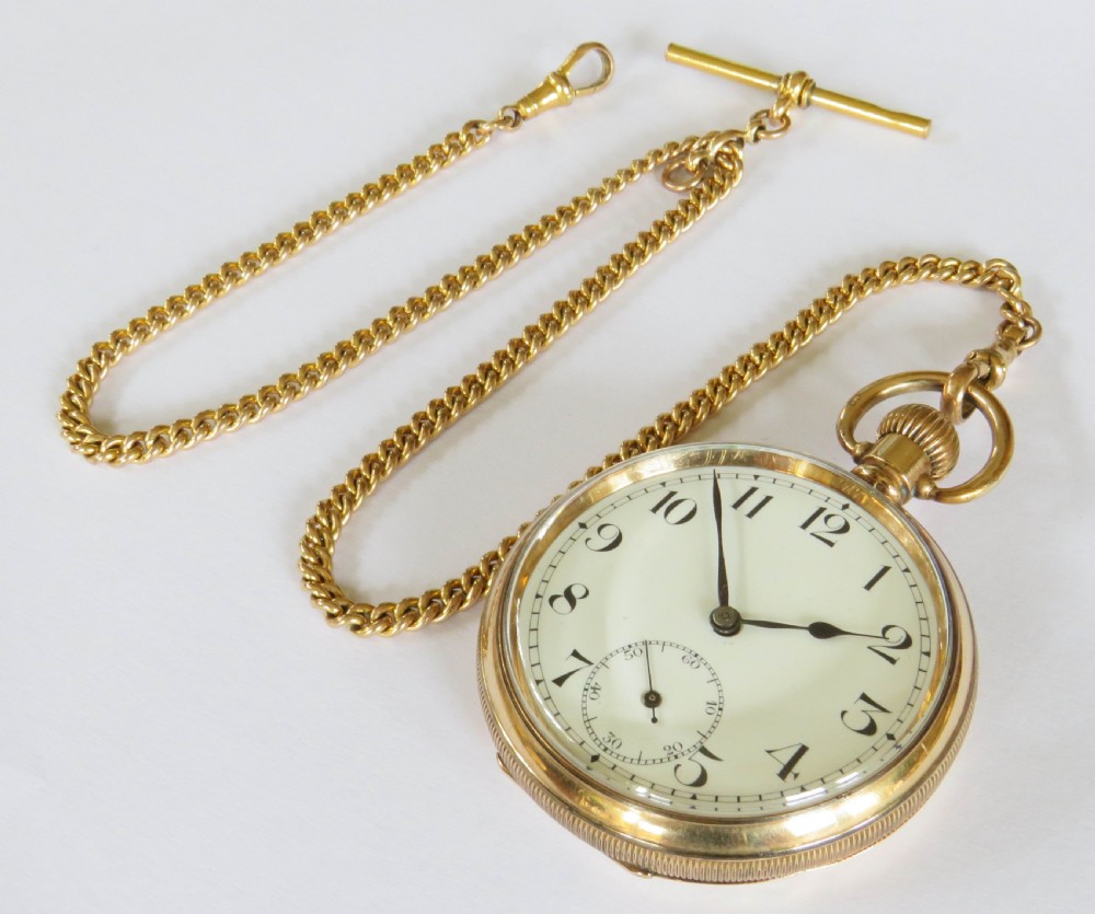 A 1920s gold-toned open-faced pocket watch displaying a white dial, black Arabic numerals, and a gold curb chain with a T-bar. View II