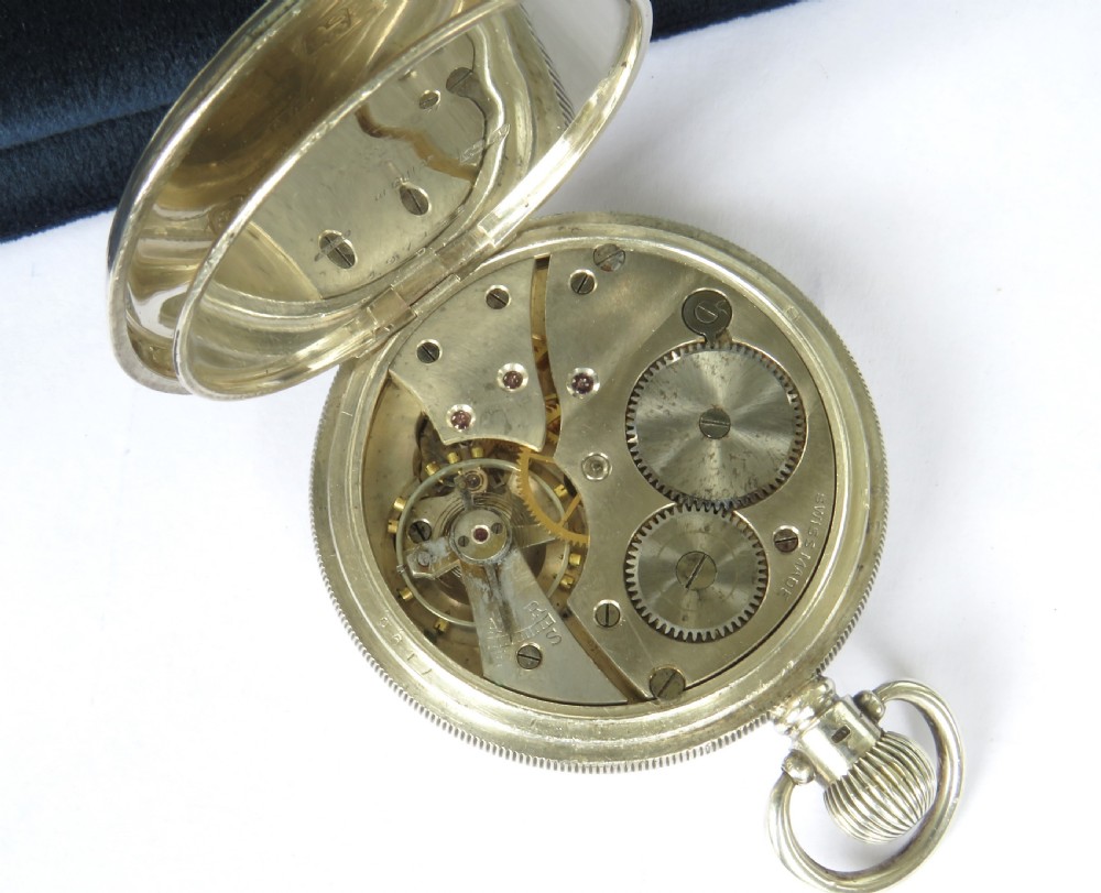 An open-face silver pocket watch with a white enamel dial, black Roman numerals, and a sub-seconds dial. View IV