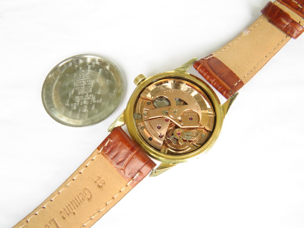 A 1960s Omega automatic wristwatch featuring a champagne dial with gold baton markers and a textured brown leather strap. View III