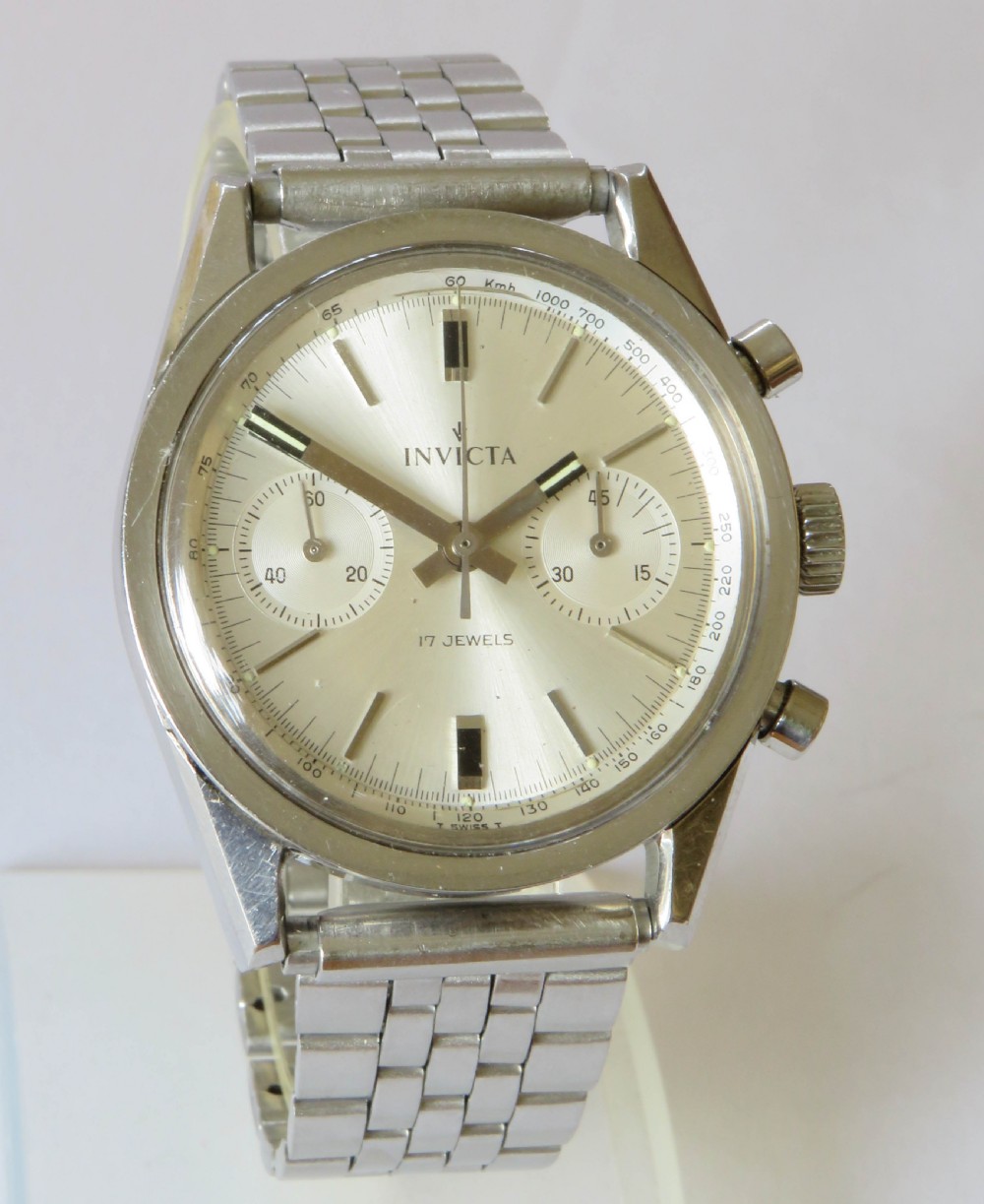 A 1960s Invicta chronograph wristwatch with a silver dial, twin sub-dials, baton indices, and a stainless steel bracelet. View II