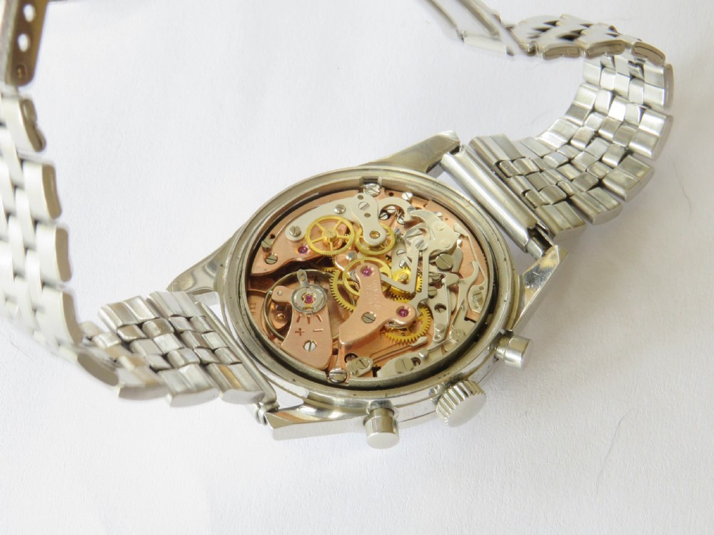 A 1960s Invicta chronograph wristwatch with a silver dial, twin sub-dials, baton indices, and a stainless steel bracelet. View III