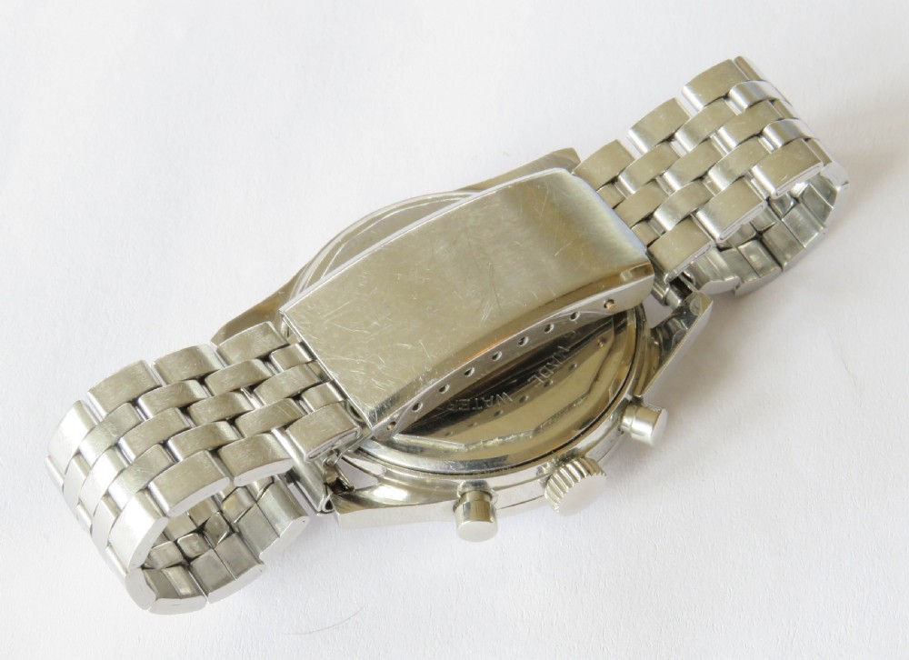 A 1960s Invicta chronograph wristwatch with a silver dial, twin sub-dials, baton indices, and a stainless steel bracelet. View IV