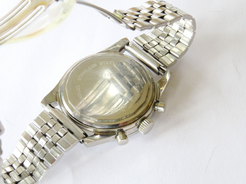 A 1960s Invicta chronograph wristwatch with a silver dial, twin sub-dials, baton indices, and a stainless steel bracelet. View V