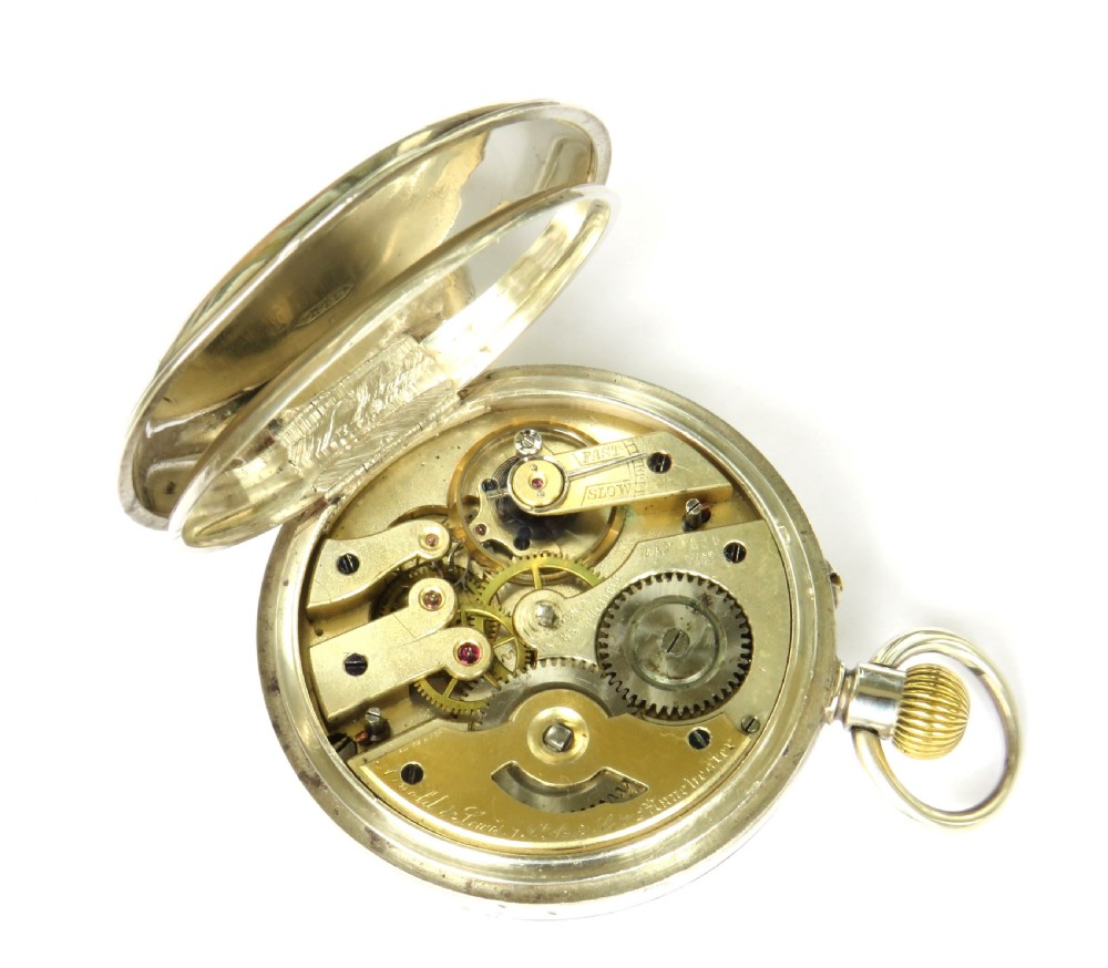 An open-faced silver pocket watch with a white enamel dial, black Roman numerals, a subsidiary seconds dial, and a ribbed brass onion crown. View IV