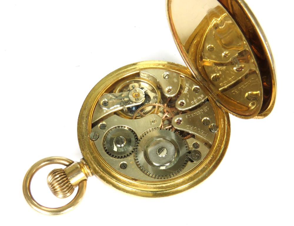 A 1920s open-face gold-toned pocket watch with a white enamel dial, black Roman numerals, and a subsidiary seconds track at six oclock. View IV
