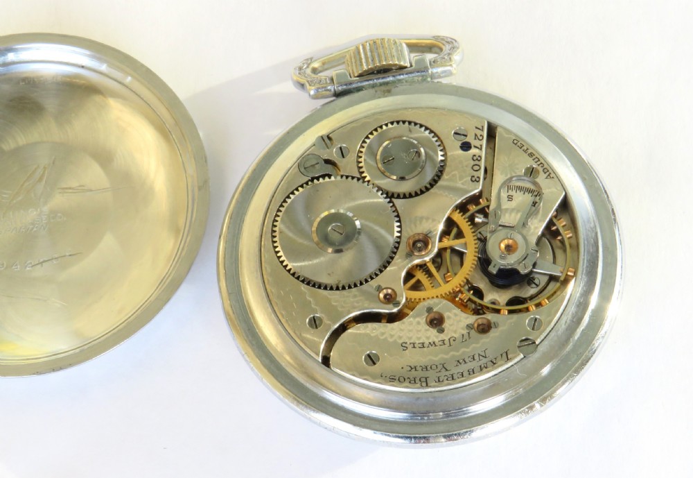 An antique open-face pocket watch featuring a white enamel dial with black Arabic numerals, blued steel hands, a sub-seconds dial, and an engraved metal bezel. View III