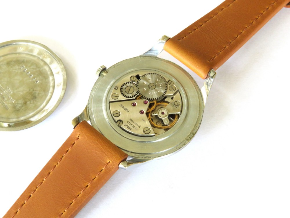 A vintage 1950s Marvin gents wristwatch featuring a cream dial with gold-tone markers and a tan leather strap. View III