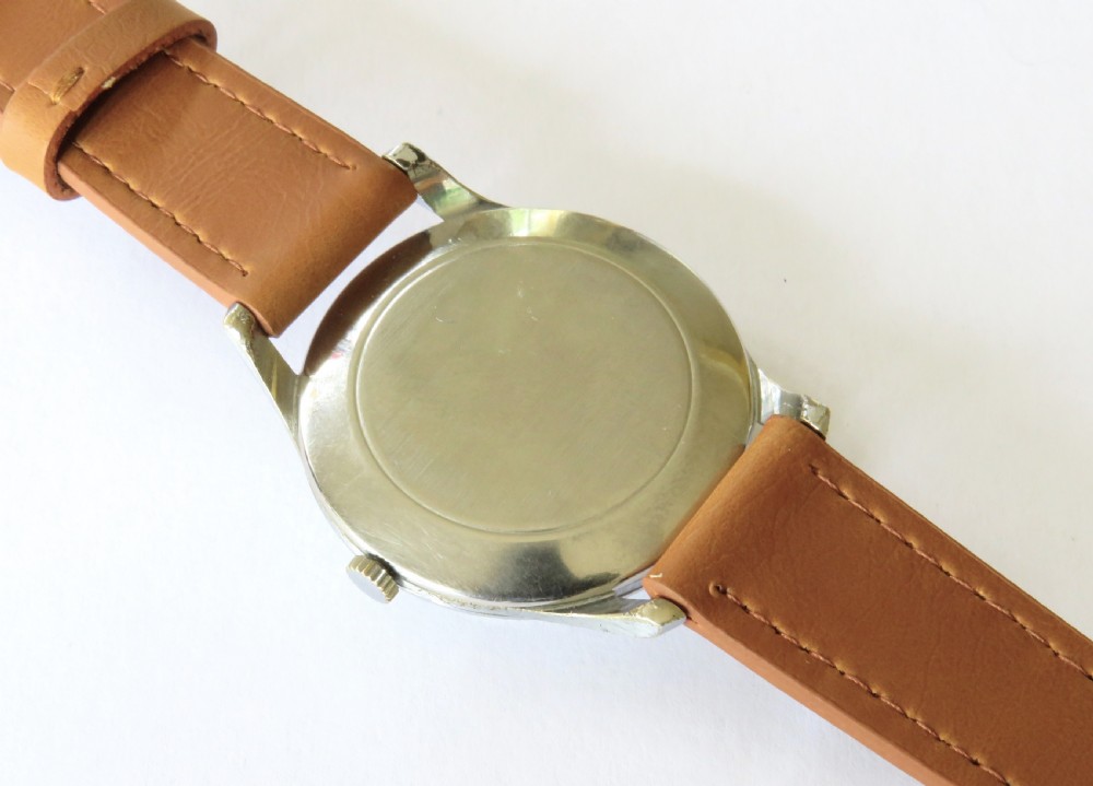 A vintage 1950s Marvin gents wristwatch featuring a cream dial with gold-tone markers and a tan leather strap. View IV