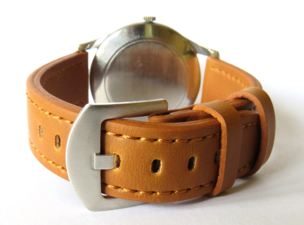 A vintage 1950s Marvin gents wristwatch featuring a cream dial with gold-tone markers and a tan leather strap. View V