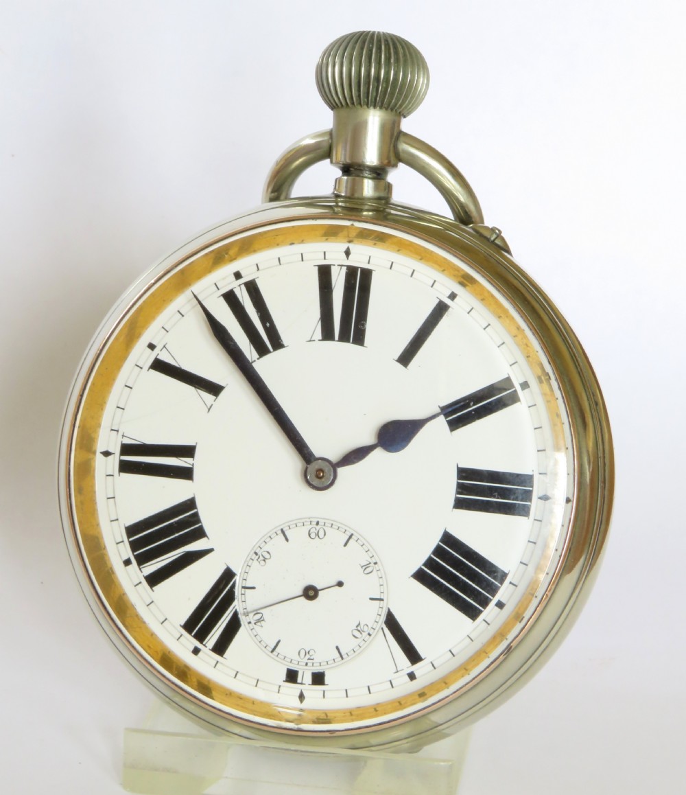 An antique goliath pocket watch featuring a white enamel dial with black Roman numerals, a sub-seconds dial, an onion crown, and a metallic case with a gilded inner bezel. View II