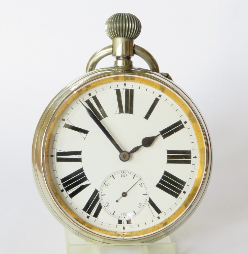 An antique goliath pocket watch featuring a white enamel dial with black Roman numerals, a sub-seconds dial, an onion crown, and a metallic case with a gilded inner bezel. View III
