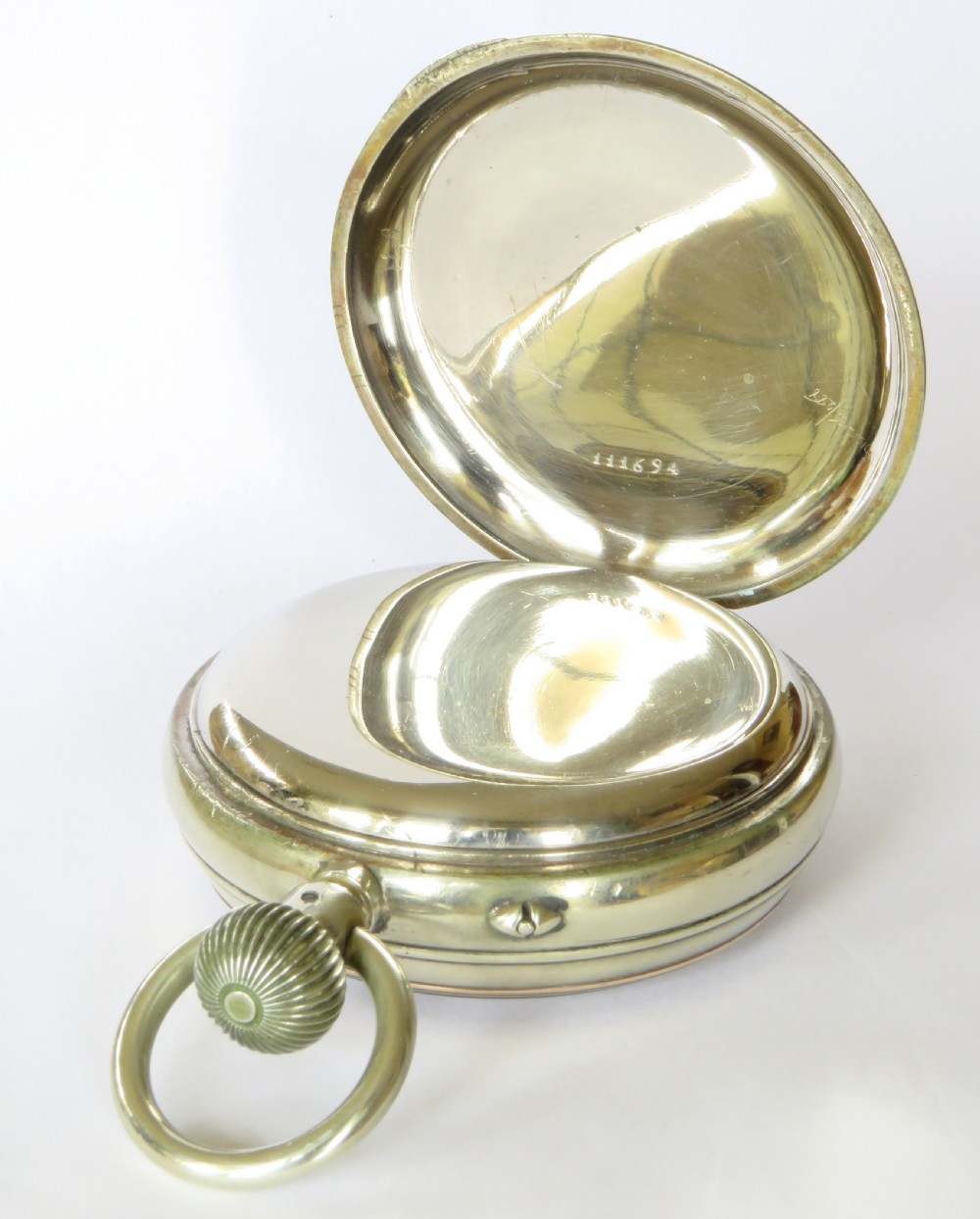An antique goliath pocket watch featuring a white enamel dial with black Roman numerals, a sub-seconds dial, an onion crown, and a metallic case with a gilded inner bezel. View IV