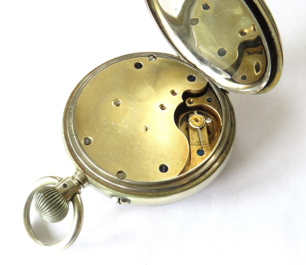 An antique goliath pocket watch featuring a white enamel dial with black Roman numerals, a sub-seconds dial, an onion crown, and a metallic case with a gilded inner bezel. View V