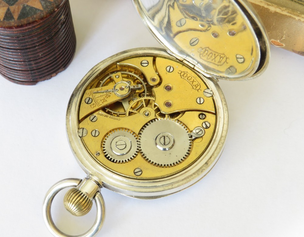 An open-face antique silver pocket watch with a white enamel dial, black Roman numerals, sub-seconds dial, and a ribbed crown. View IV