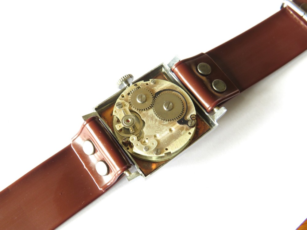 A gents 1940s Sperina wristwatch featuring a square copper-coloured dial, black Arabic numerals, a red second hand, and a brown riveted strap. View III