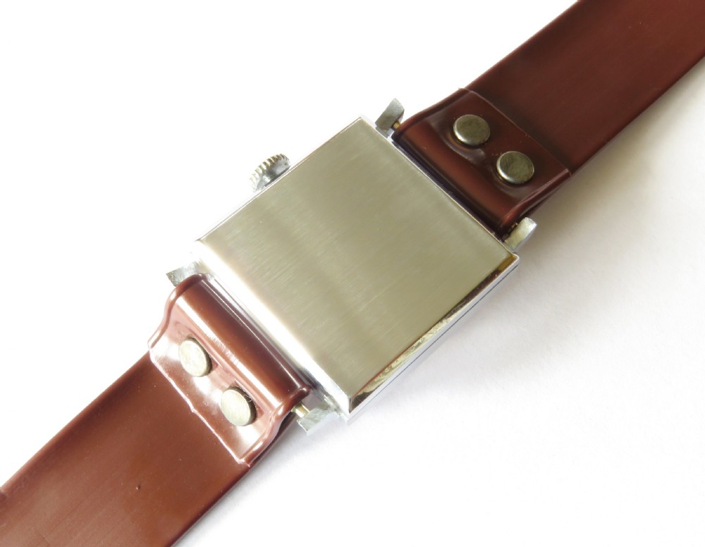 A gents 1940s Sperina wristwatch featuring a square copper-coloured dial, black Arabic numerals, a red second hand, and a brown riveted strap. View IV