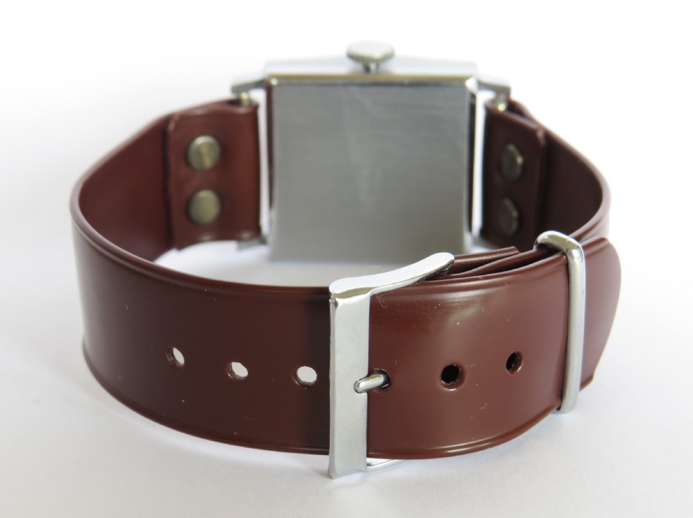 A gents 1940s Sperina wristwatch featuring a square copper-coloured dial, black Arabic numerals, a red second hand, and a brown riveted strap. View V