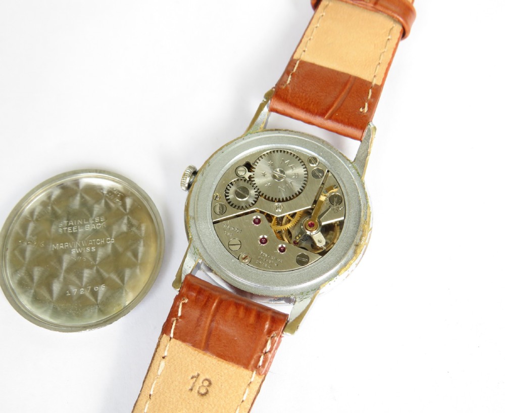 A gents 1940s Swiss-made Marvin wrist watch featuring a cream dial with Arabic numerals, a sub-seconds dial, a metallic case, and a brown leather strap. View III