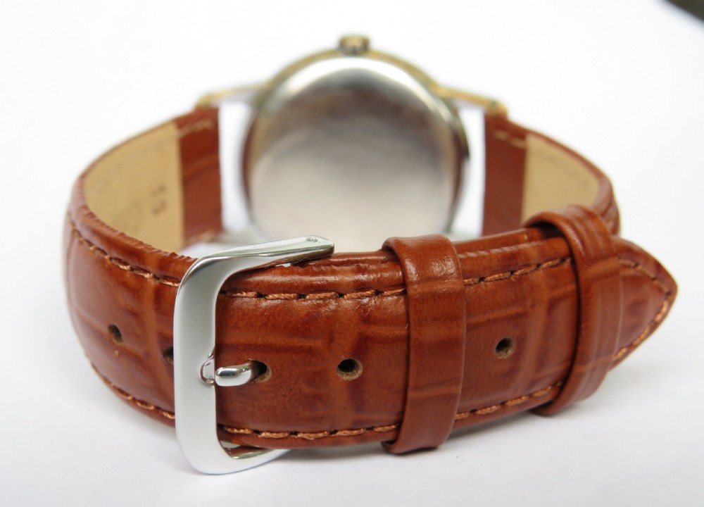 A gents 1940s Swiss-made Marvin wrist watch featuring a cream dial with Arabic numerals, a sub-seconds dial, a metallic case, and a brown leather strap. View V