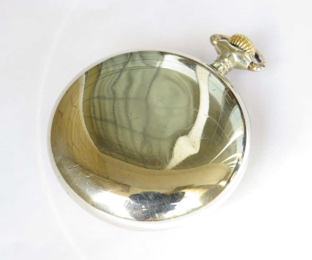 An open-face Edwardian pocket watch featuring a white enamel dial with black Arabic numerals, a subsidiary seconds dial, and a silver-toned metal case. View IV