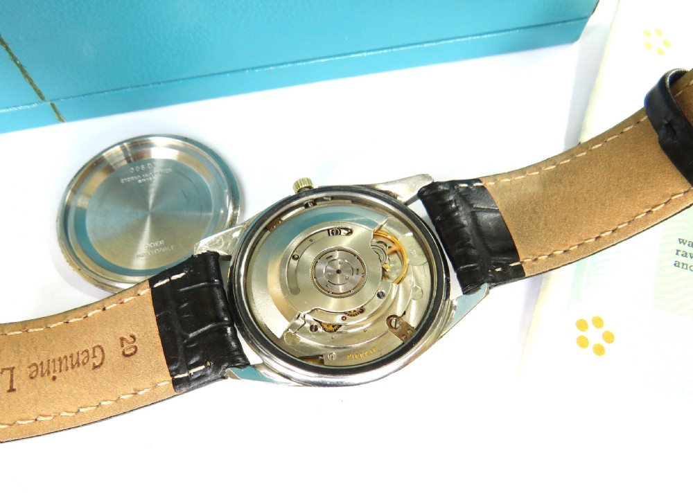 A 1960s mens gold-plated Eterna-Matic 3000 automatic wristwatch featuring a champagne dial, date aperture, and black leather strap. View III