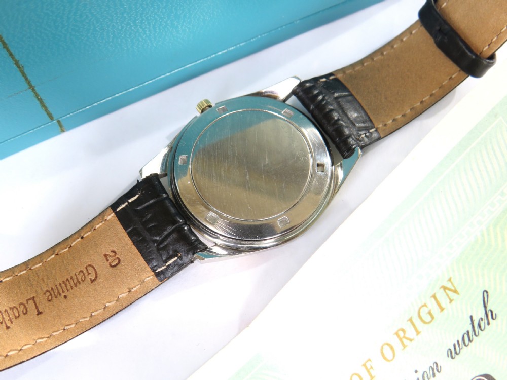 A 1960s mens gold-plated Eterna-Matic 3000 automatic wristwatch featuring a champagne dial, date aperture, and black leather strap. View IV