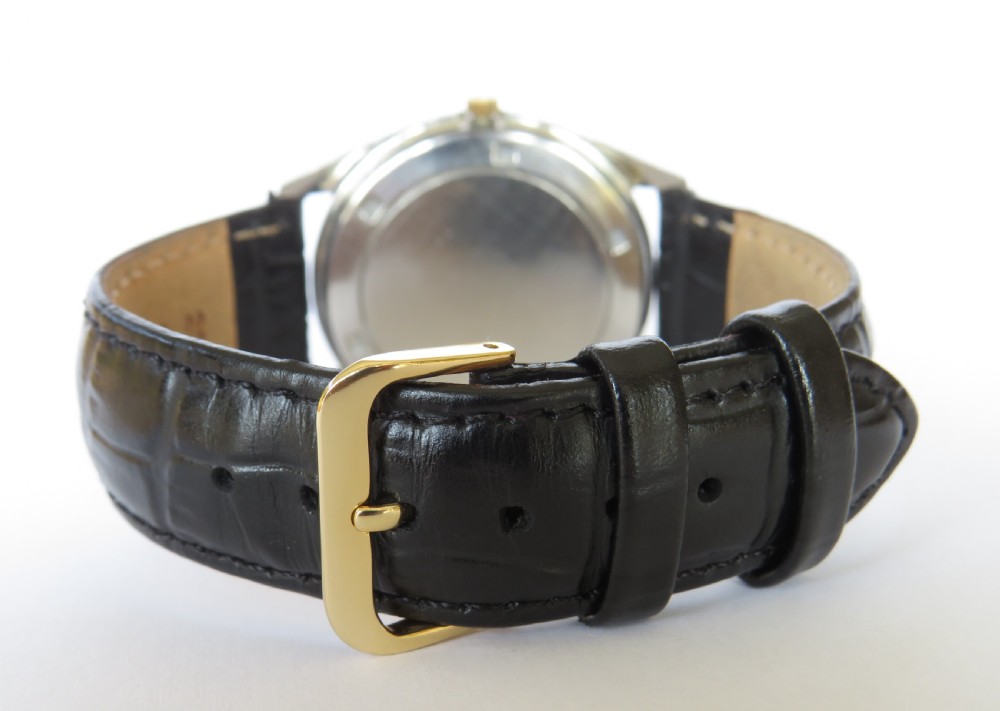 A 1960s mens gold-plated Eterna-Matic 3000 automatic wristwatch featuring a champagne dial, date aperture, and black leather strap. View VI