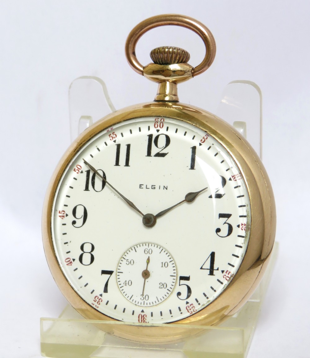 An antique open-face Elgin pocket watch featuring a gold-toned case, white enamel dial with black Arabic numerals, red minute markers, and a sub-seconds dial at six oclock. View II
