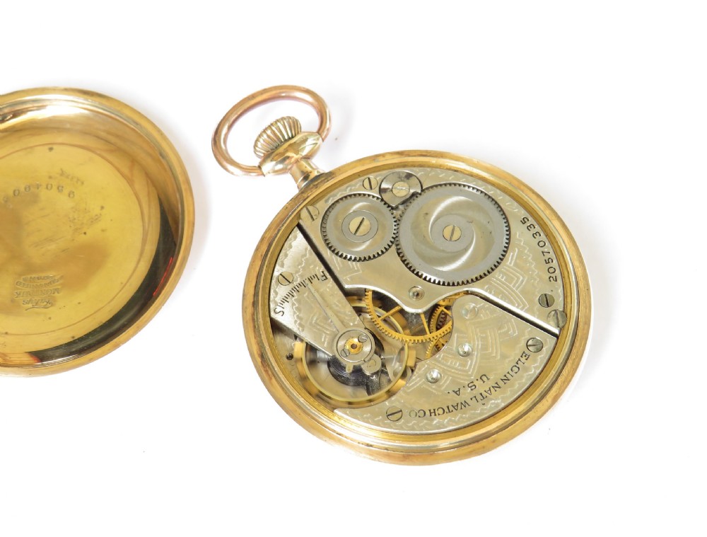 An antique open-face Elgin pocket watch featuring a gold-toned case, white enamel dial with black Arabic numerals, red minute markers, and a sub-seconds dial at six oclock. View IV