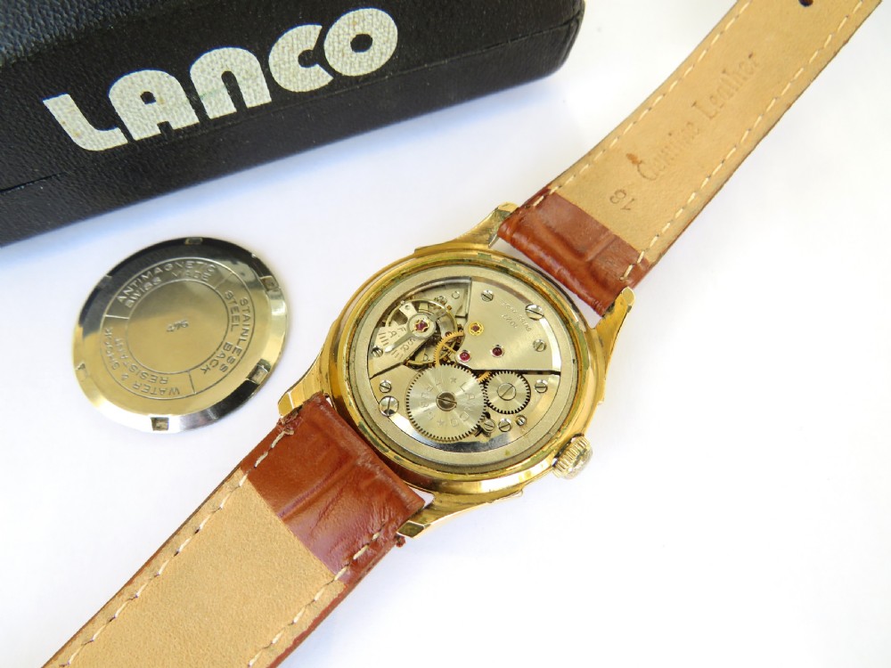 A 1950s gents Lanco Sport Swiss mechanical wristwatch featuring a gold-plated case, cream dial with arrow indices, and a textured brown leather strap. View III